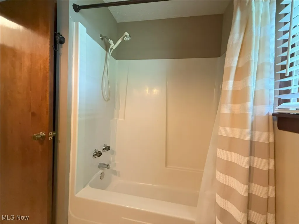 Full bathroom with shower / tub combo