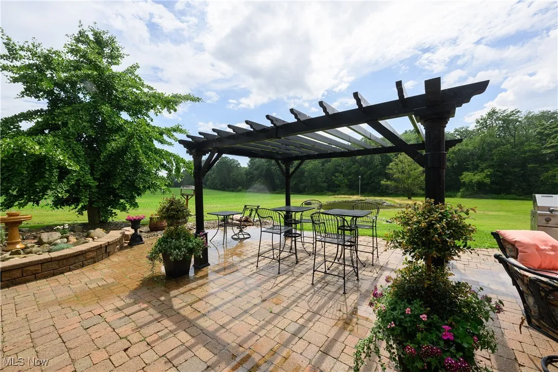 View of patio featuring a pergola and outdoor dining space