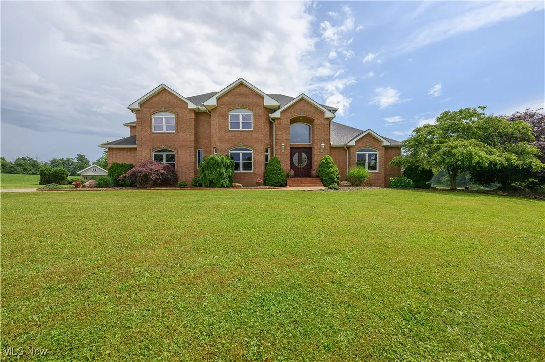 View of front of property featuring a front yard and brick siding