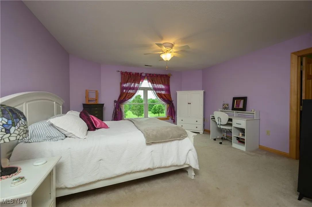 Bedroom with carpet floors and a ceiling fan