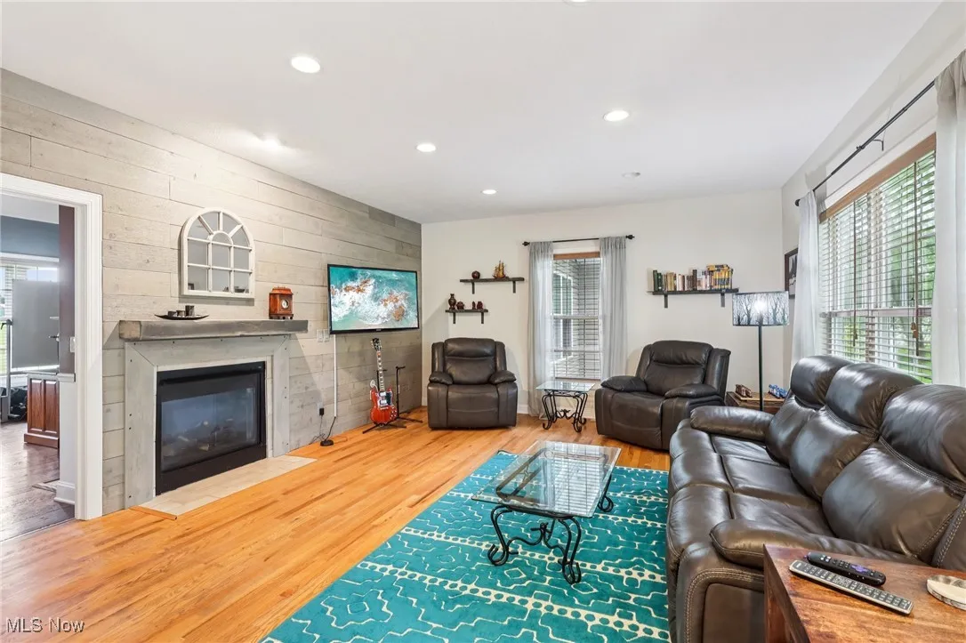The family room is open to the kitchen and shares the fireplace with the office.