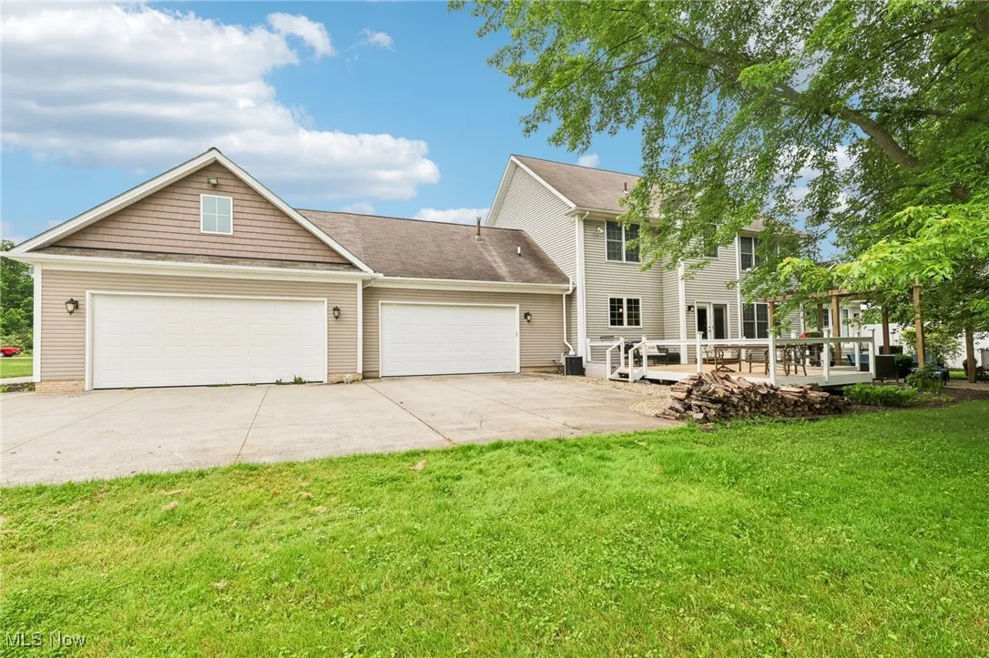 The oversized 3-car garage area and large concrete bay space behind the house.
