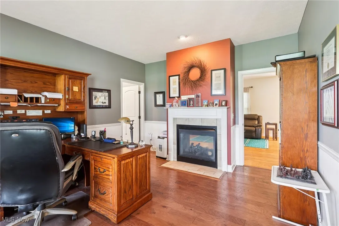 The office shares the fireplace with the family room, and is adjacent to the sitting room.