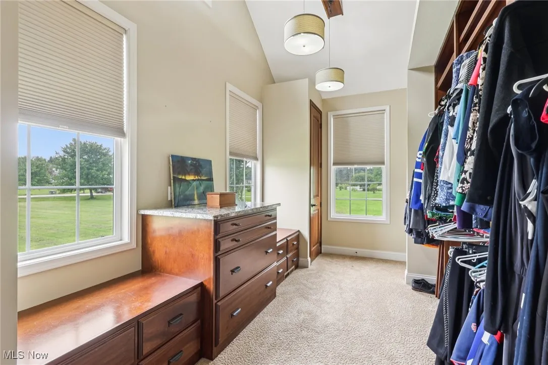 A view of the walk through closet and dressing area.