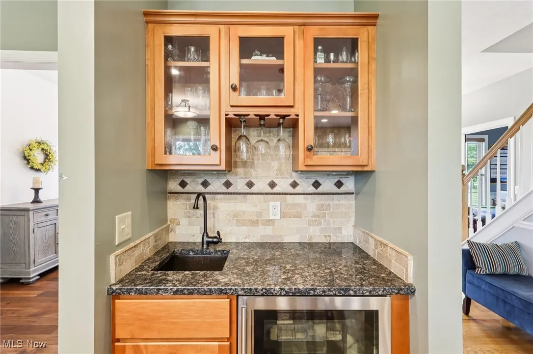 Wet bar with hammered copper sink.
