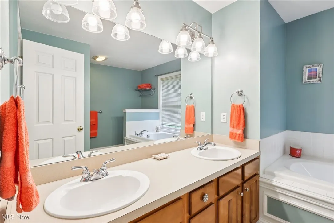 Full bathroom for the second floor bedroom suite has a jetted tub and stall shower.
