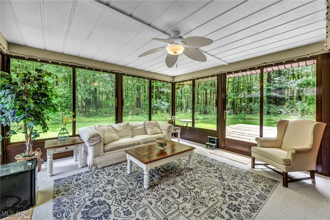 Sunroom featuring ceiling fan and an outdoor hangout area
