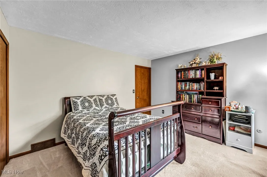 Bedroom featuring carpet flooring and a textured ceiling