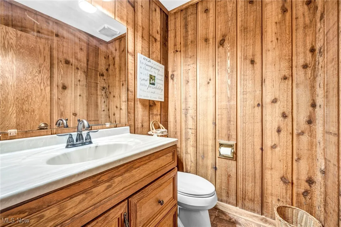 Bathroom with vanity and wooden walls