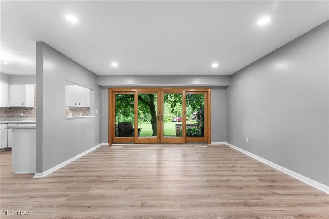 Unfurnished living room with light wood finished floors and recessed lighting