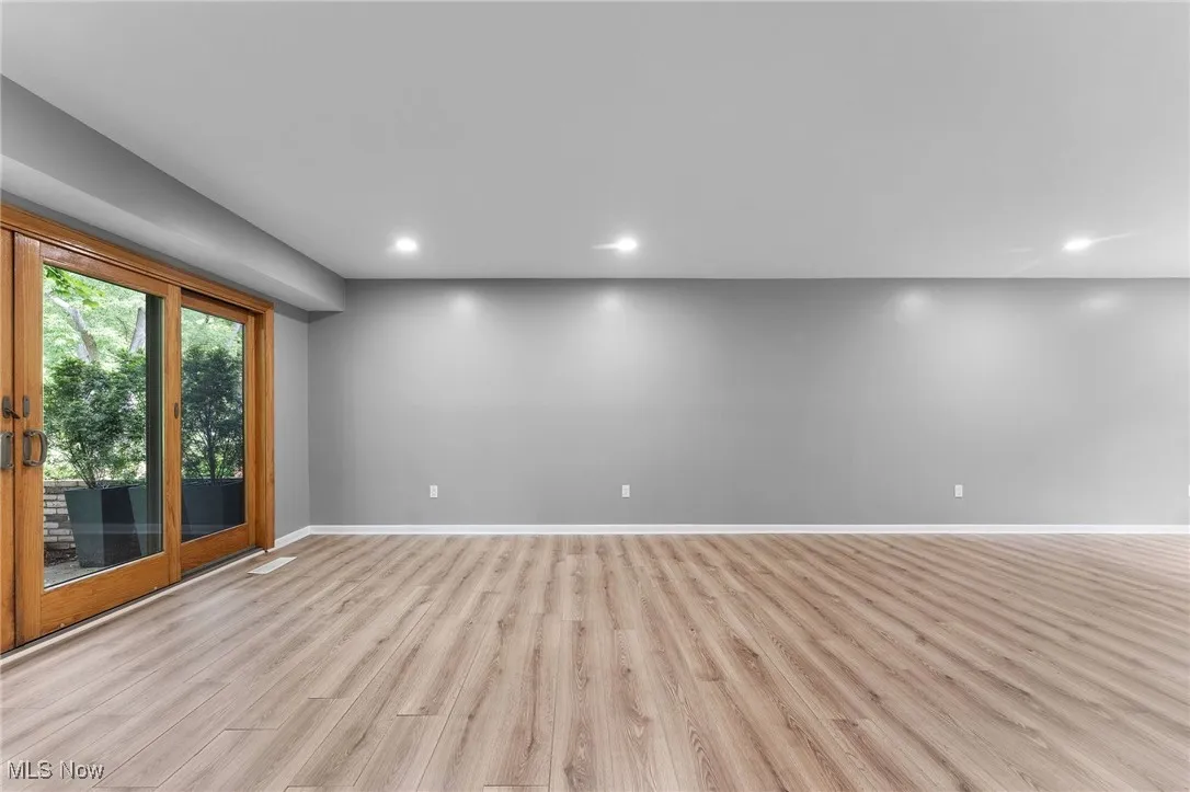 Spare room featuring light wood finished floors and recessed lighting