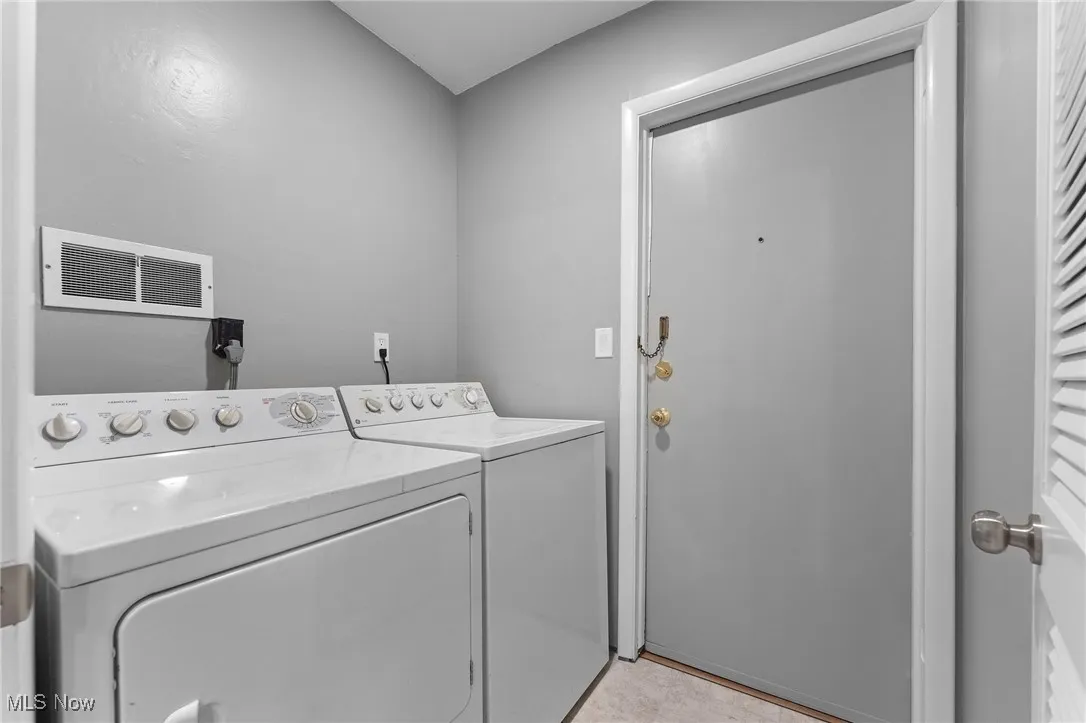 Washroom featuring independent washer and dryer