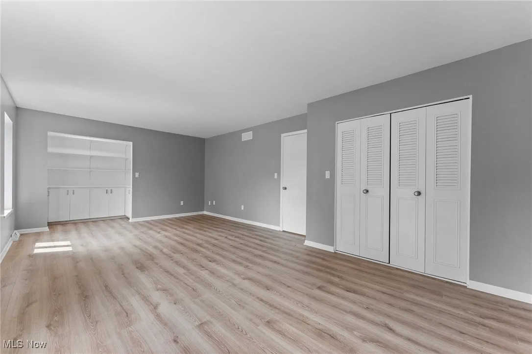 Unfurnished bedroom featuring light wood-style floors and baseboards