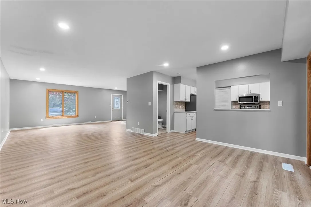 Unfurnished living room featuring recessed lighting and light wood-type flooring