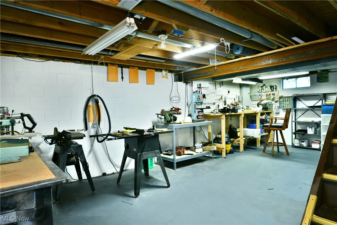 Below grade area with a workshop area and concrete block wall