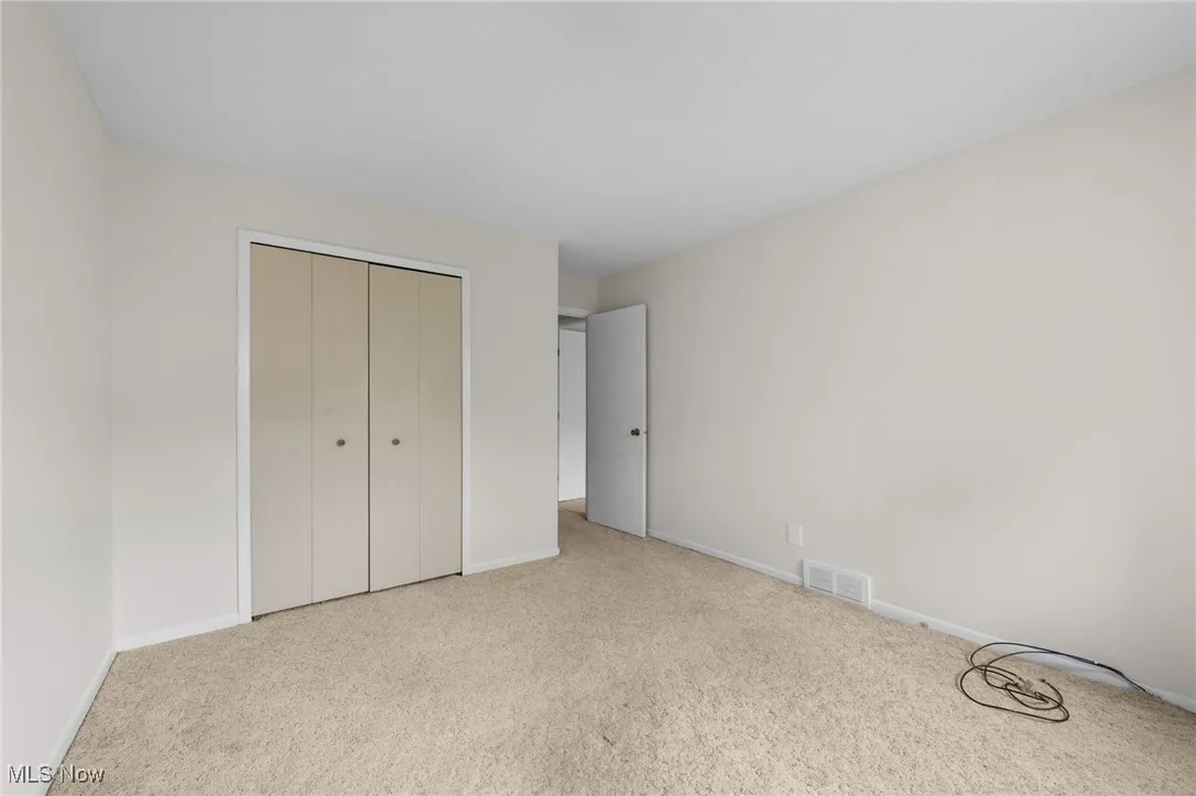 Bedroom with carpet flooring and a closet
