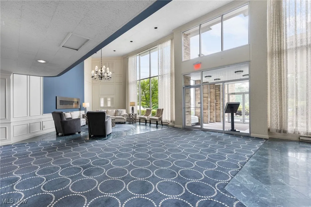 Building lobby featuring a high ceiling and a decorative wall