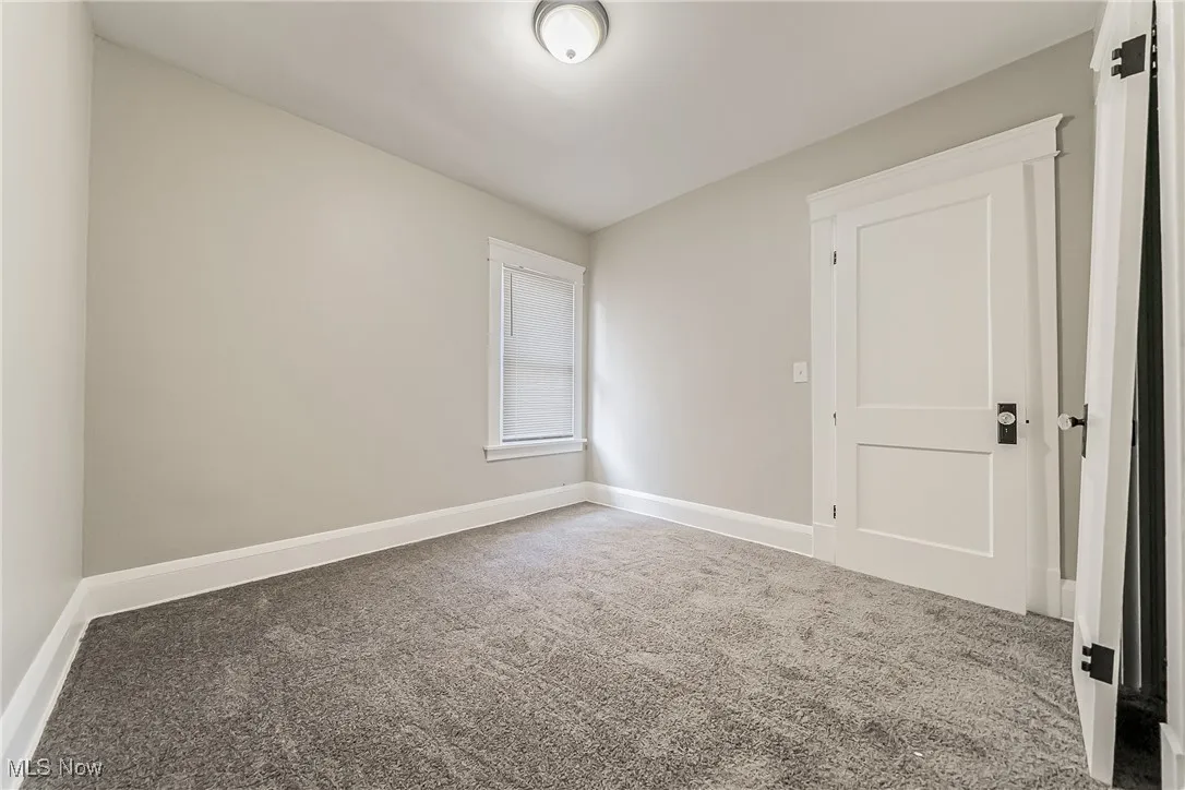 Spare room with carpet and baseboards