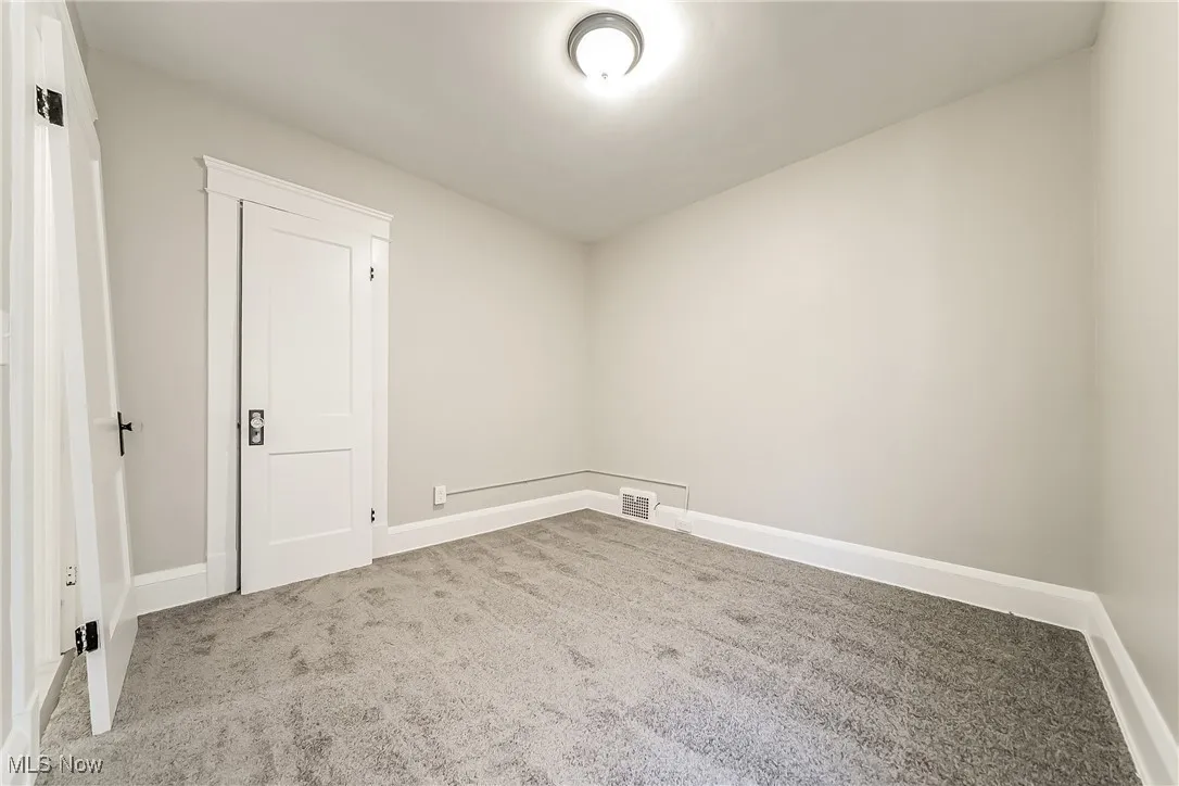 Carpeted spare room with baseboards