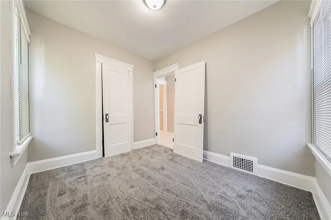 Unfurnished bedroom with carpet and baseboards