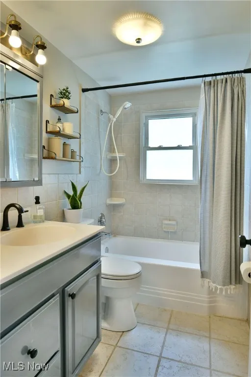 Full bathroom featuring vanity, shower / bath combo, and tile patterned floors