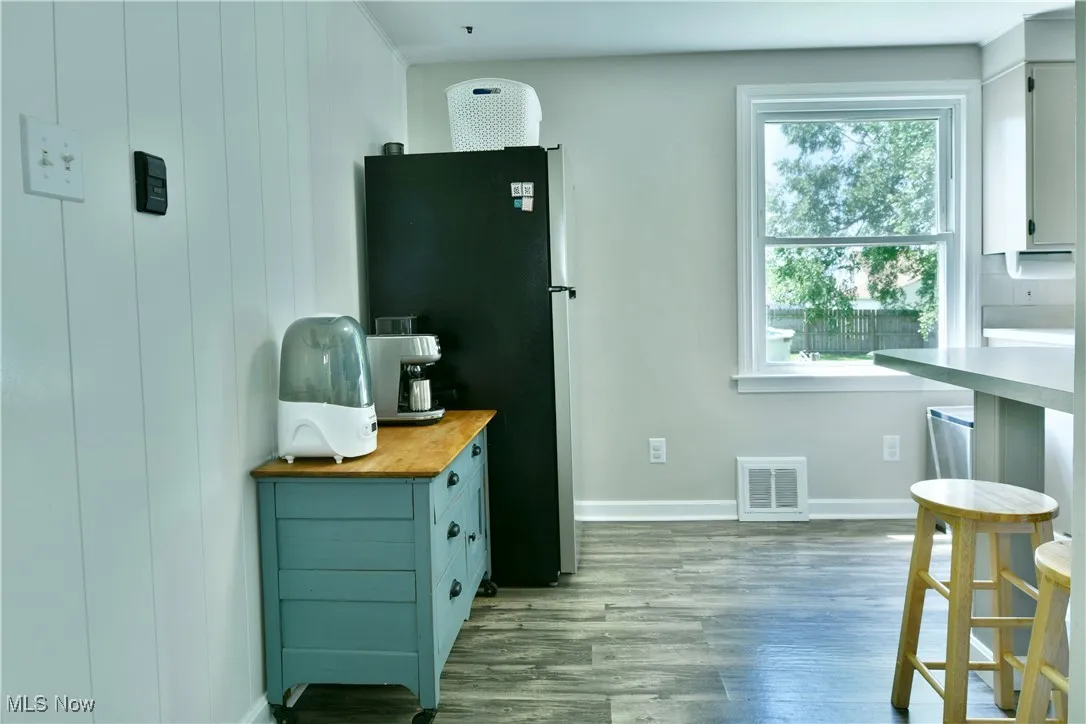 Kitchen with freestanding refrigerator, wood finished floors, and wood counters