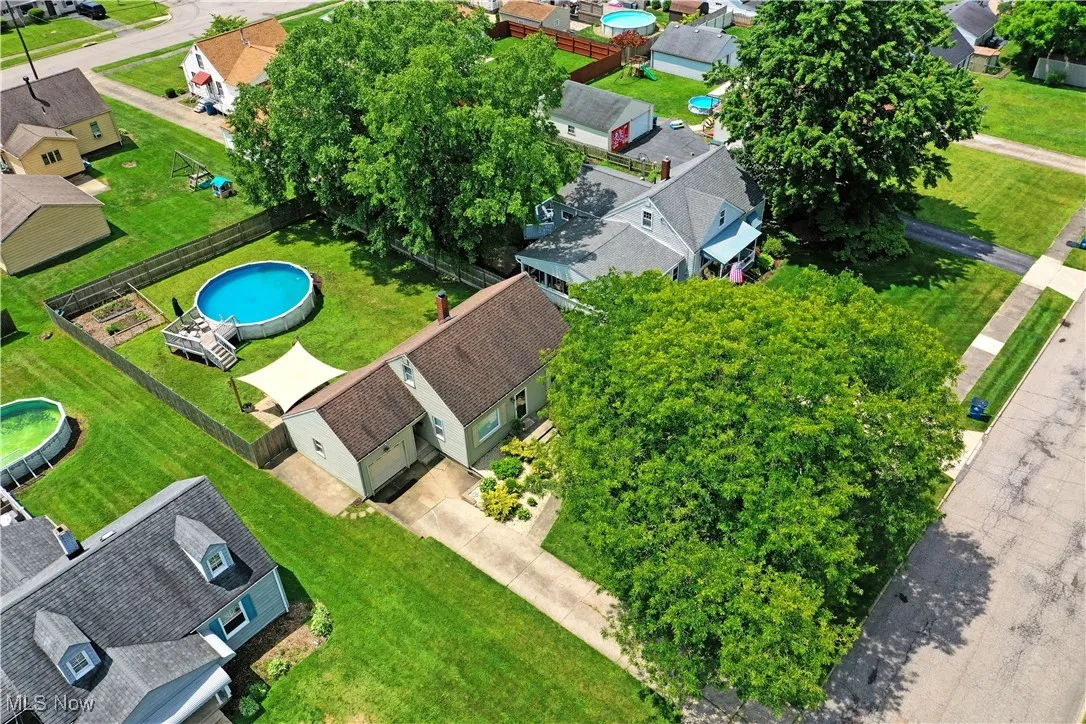 Aerial perspective of suburban area featuring a pool