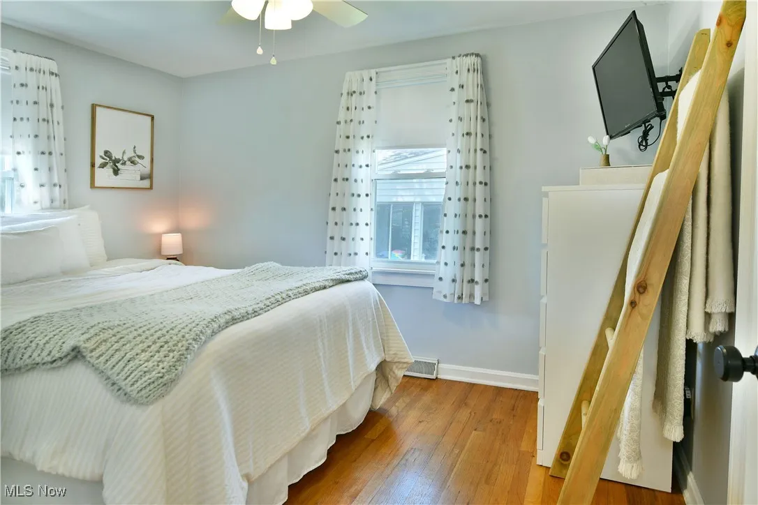 Bedroom with wood-type flooring and a ceiling fan