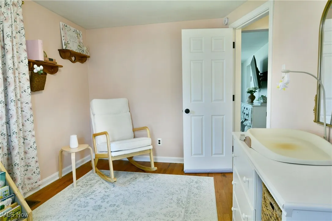 Sitting room with wood finished floors and baseboards