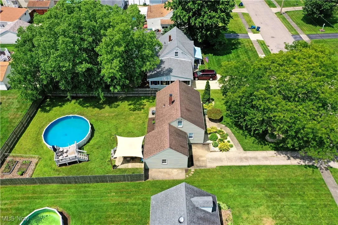 Aerial view of property and surrounding area featuring a pool