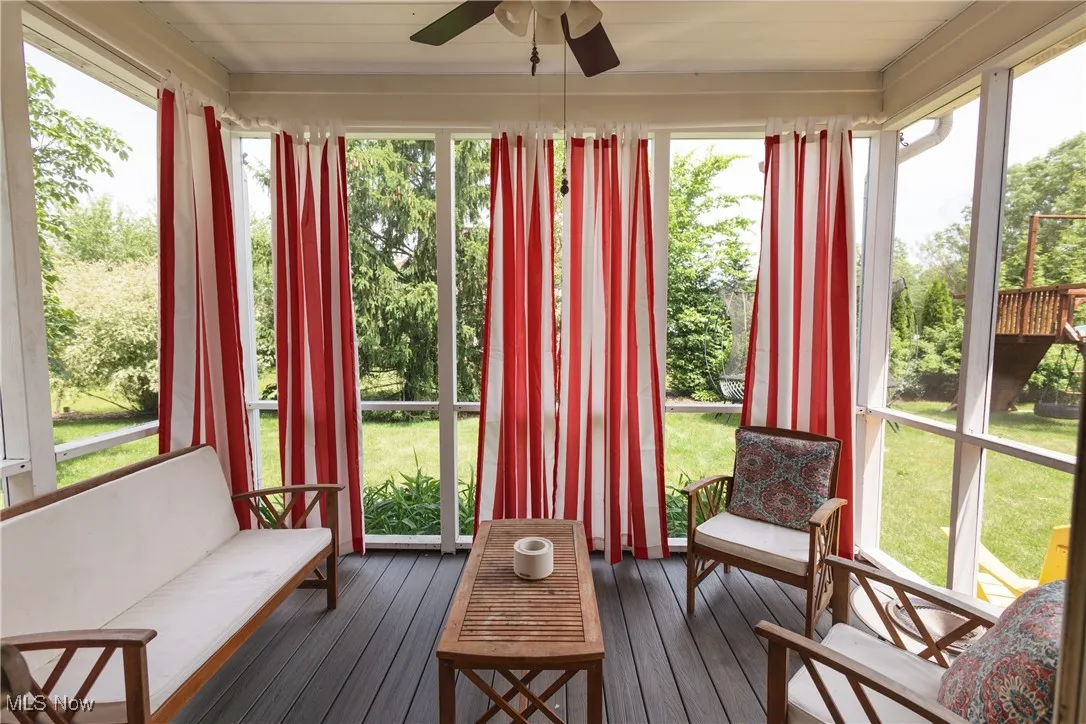 Sunroom / solarium featuring Trex decking and healthy amount of natural light