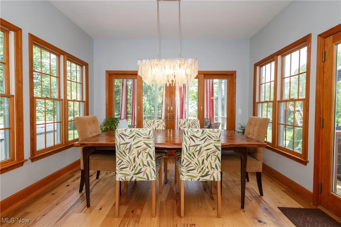 Dining area with a chandelier and hardwood flooring