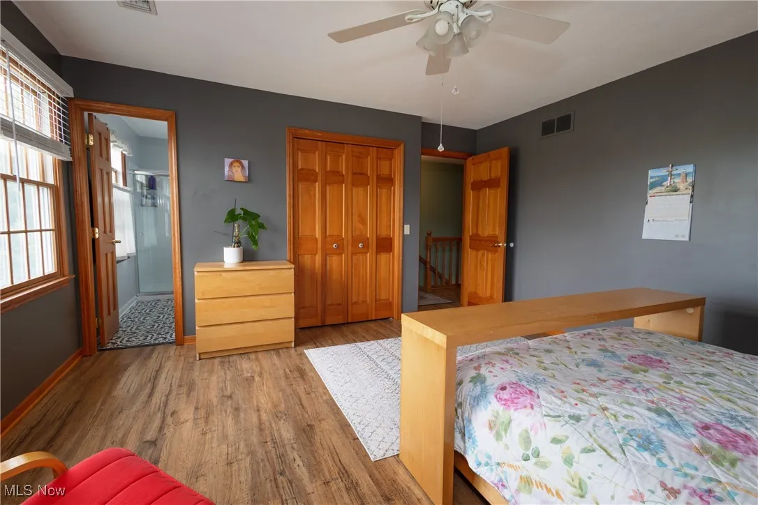 Second fl Primary Bedroom with wood finished floors, a closet, a ceiling fan, and ensuite bath
