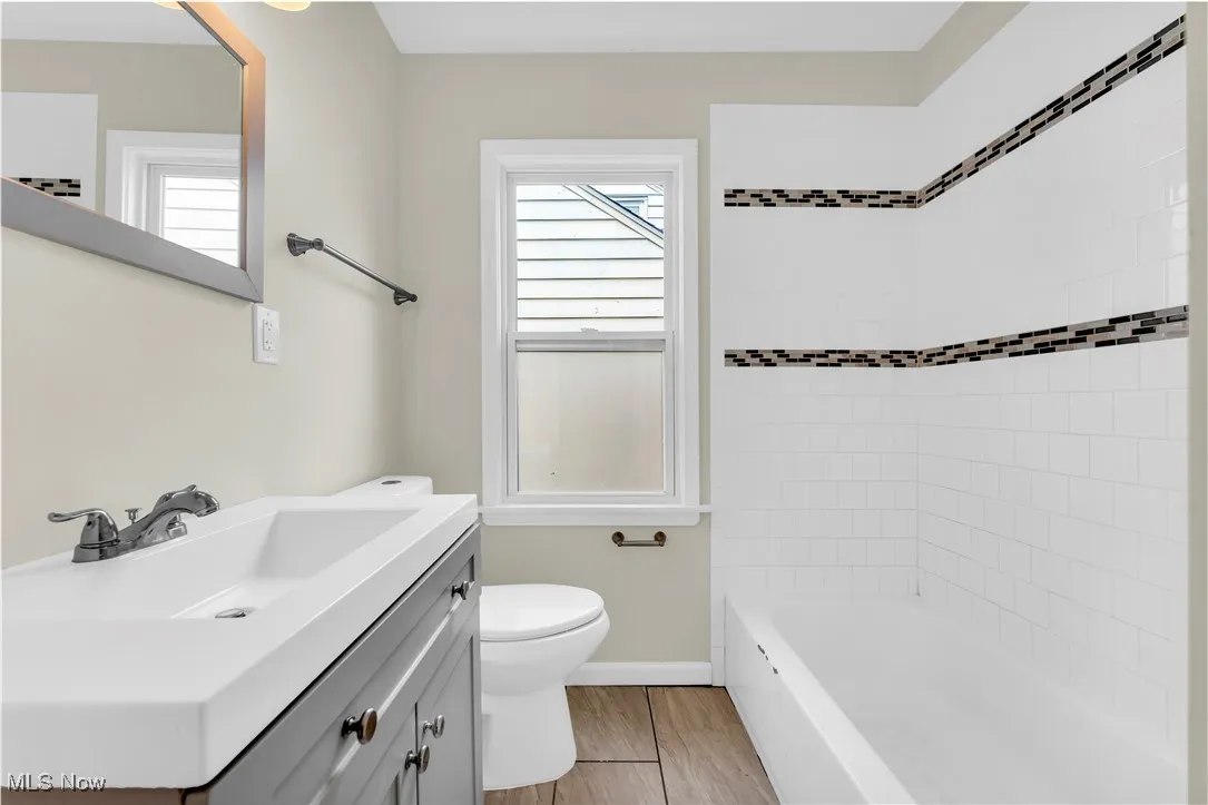 Bathroom featuring vanity and  shower combination