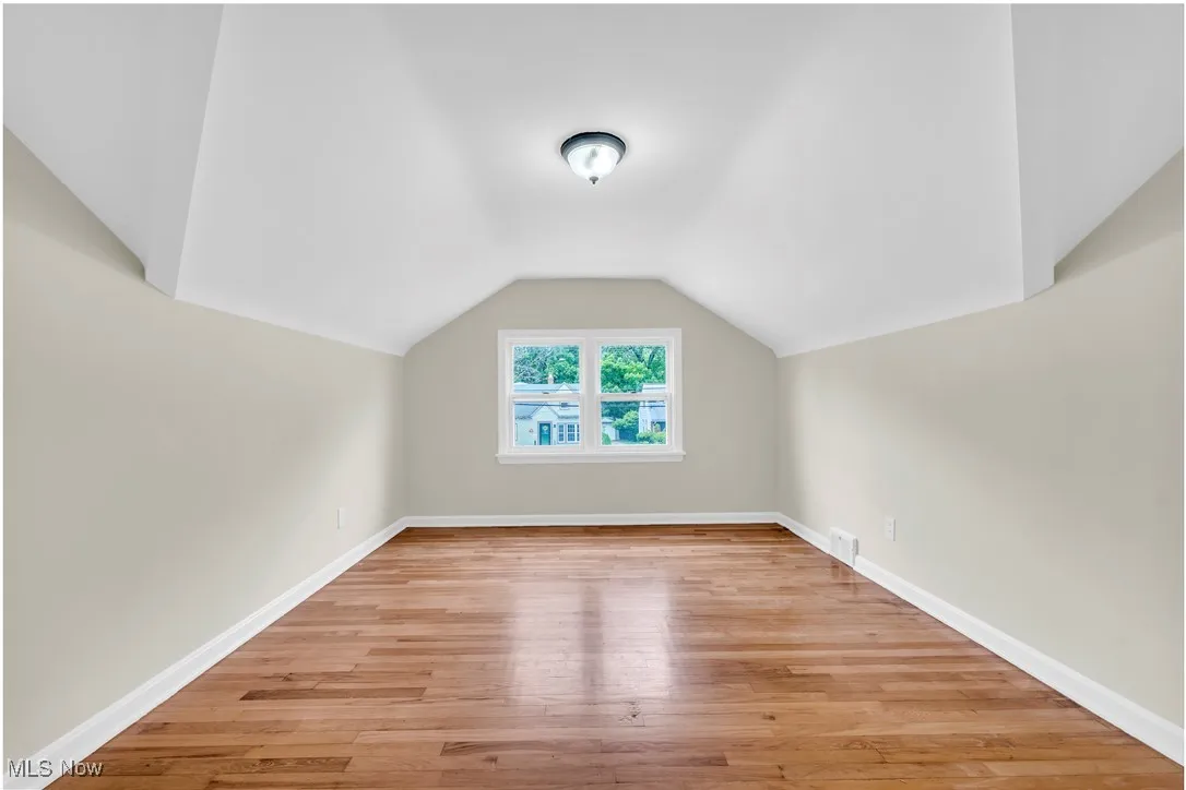 Bonus room featuring vaulted ceiling and light wood finished floors