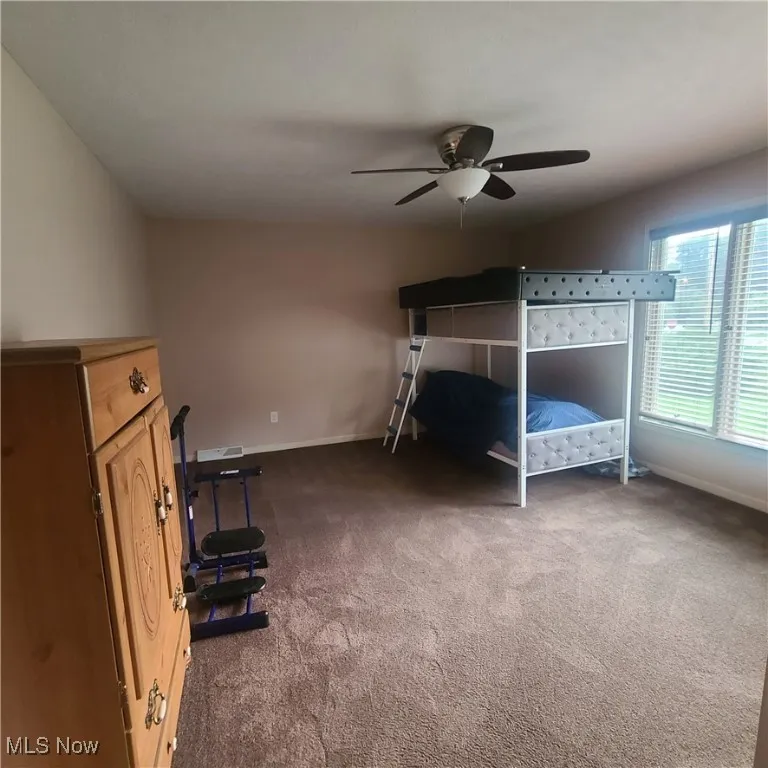 Carpeted 2nd floor front bedroom featuring a ceiling fan