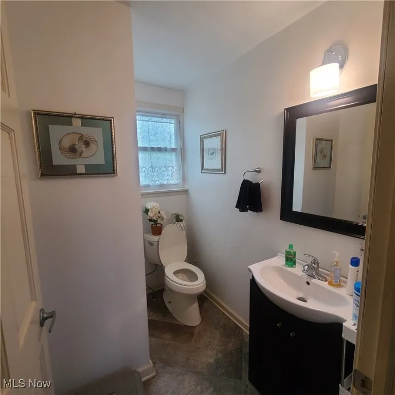 Half-Bathroom on main floor with vanity and toilet