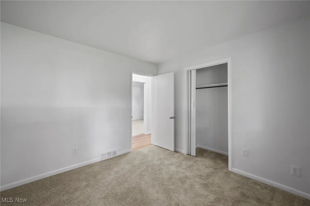 Unfurnished bedroom with carpet floors and a closet