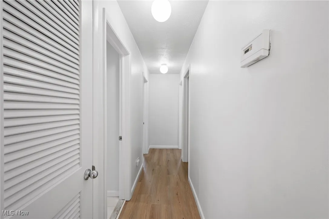 Hall featuring light wood-style floors and baseboards
