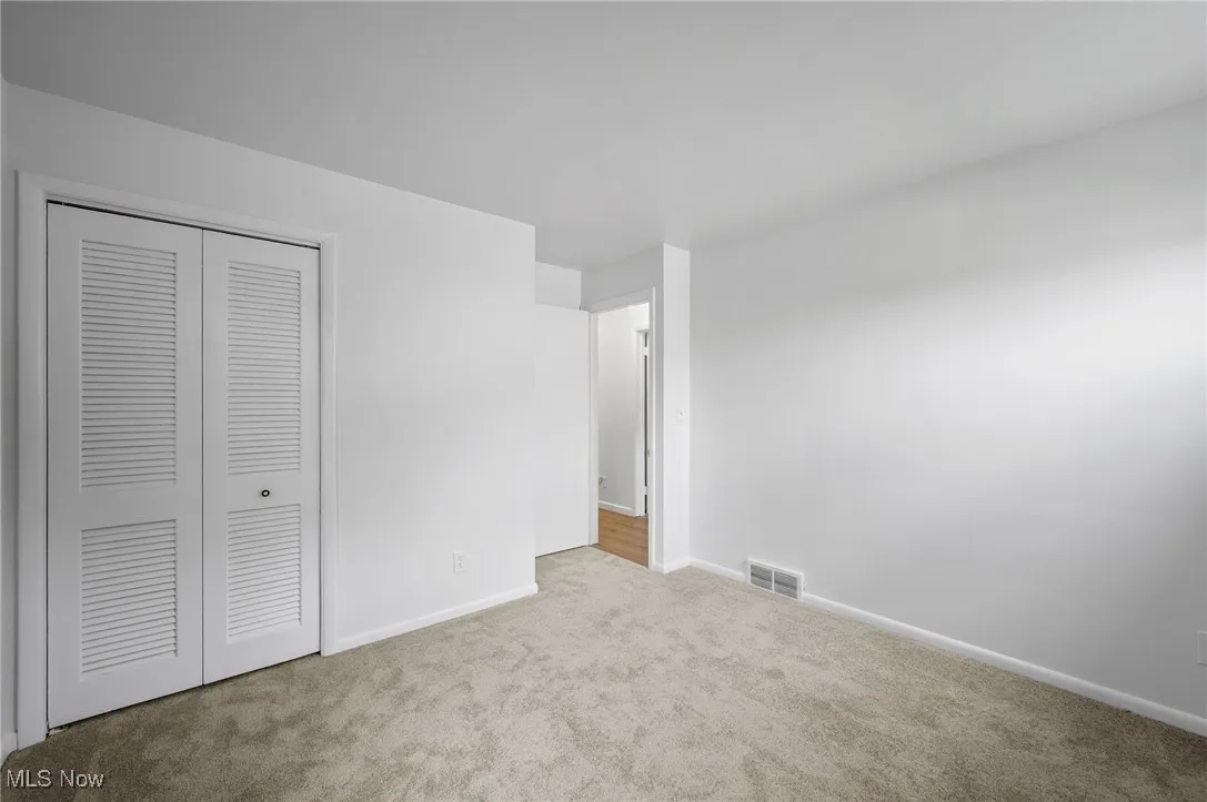 Unfurnished bedroom with carpet flooring and a closet