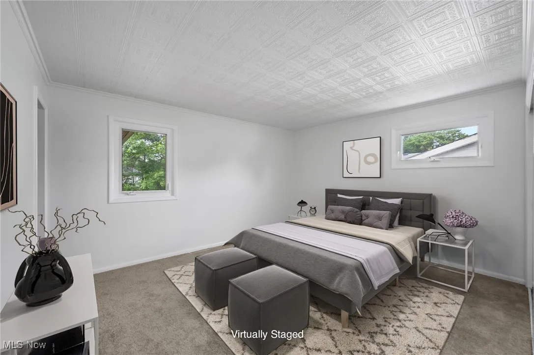 Bedroom with carpet, multiple windows, and crown molding