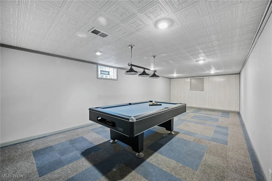 Rec room with carpet, pool table, and crown molding