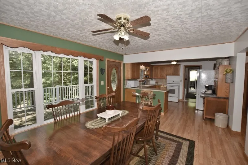 The dining room is open to the kitchen. Refrigerator and range will remain with the home.