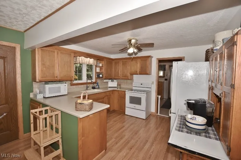 The kitchen offers nice oak cabinetry and laminate flooring