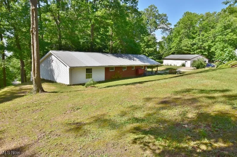 This is a view of the home with a sprawling yard.
