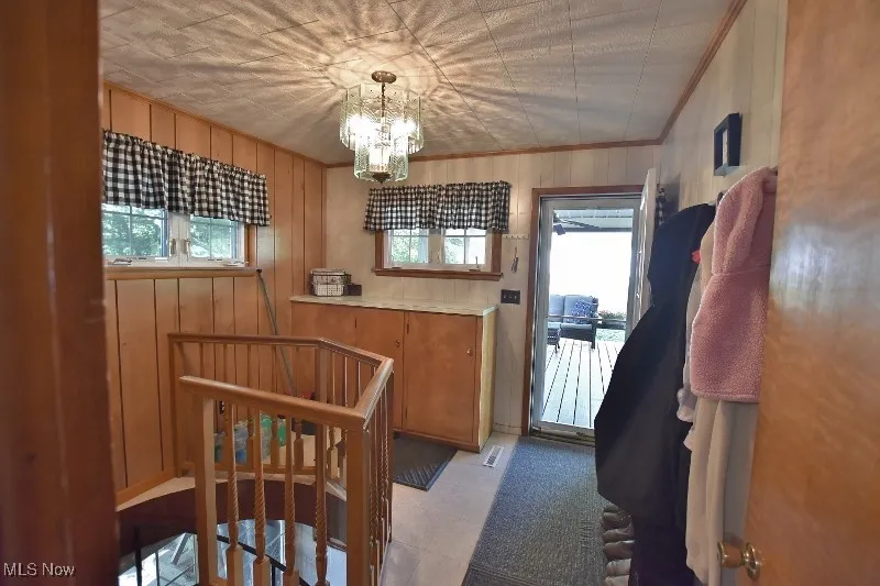 The mudroom off the covered deck. A spiral staircase leads to the lower floor.