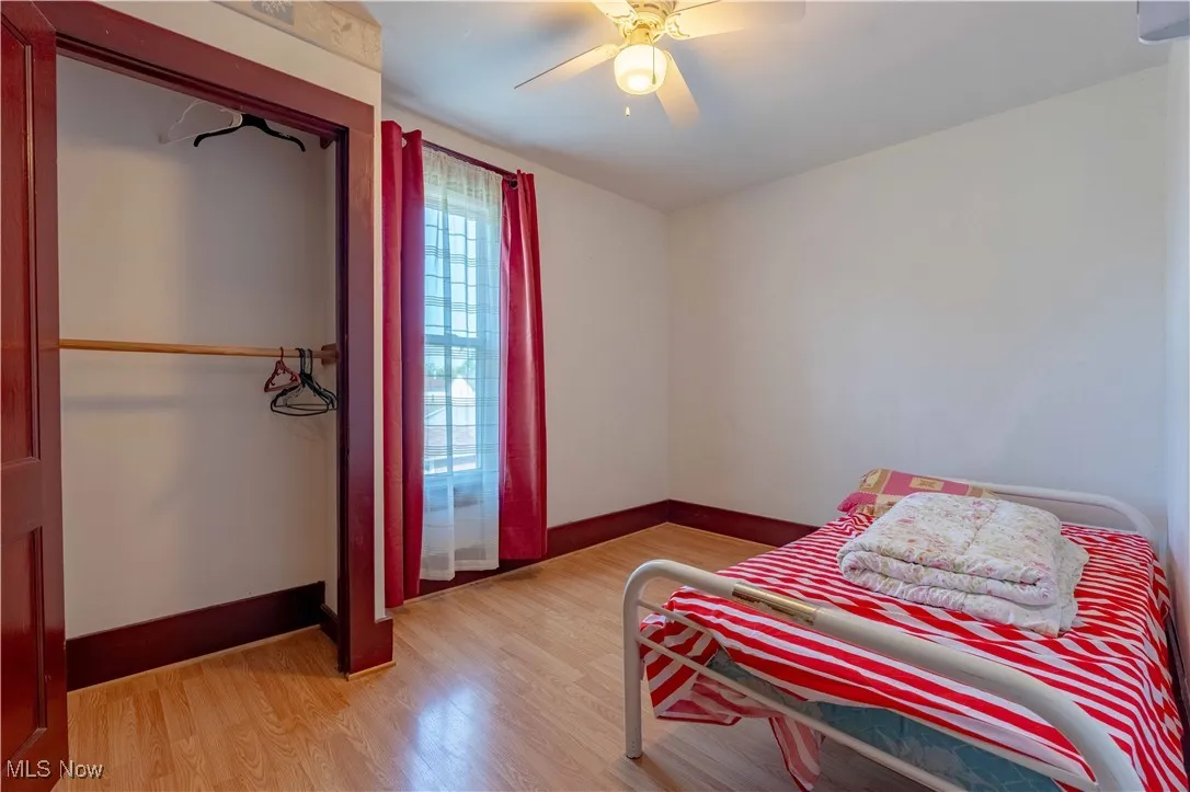 Bedroom with light wood finished floors and a ceiling fan