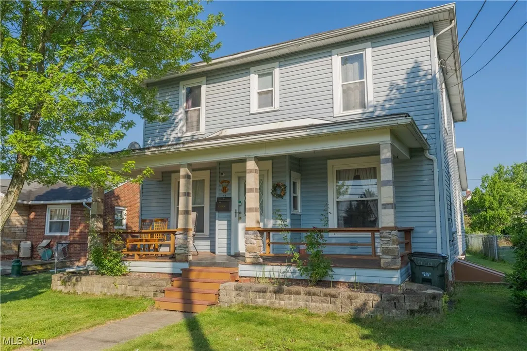 Traditional style home with a porch and a front yard