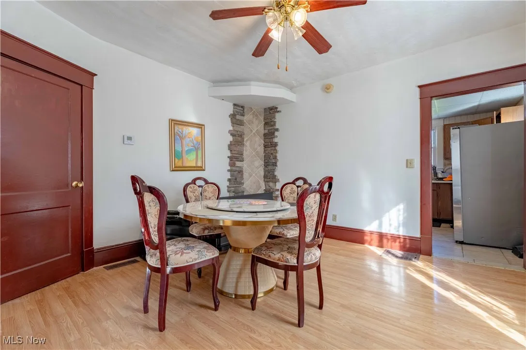 Dining area featuring light wood finished floors and a ceiling fan