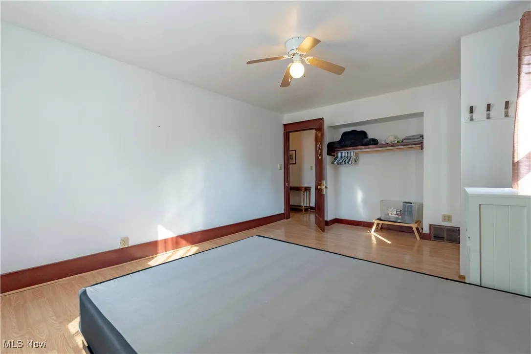 Bedroom featuring wood finished floors and a ceiling fan